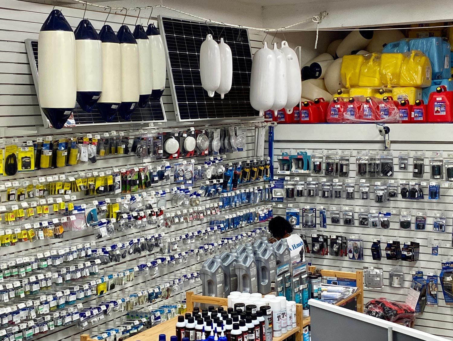 Chandlery shelves with fenders, oil, and packaged marine parts